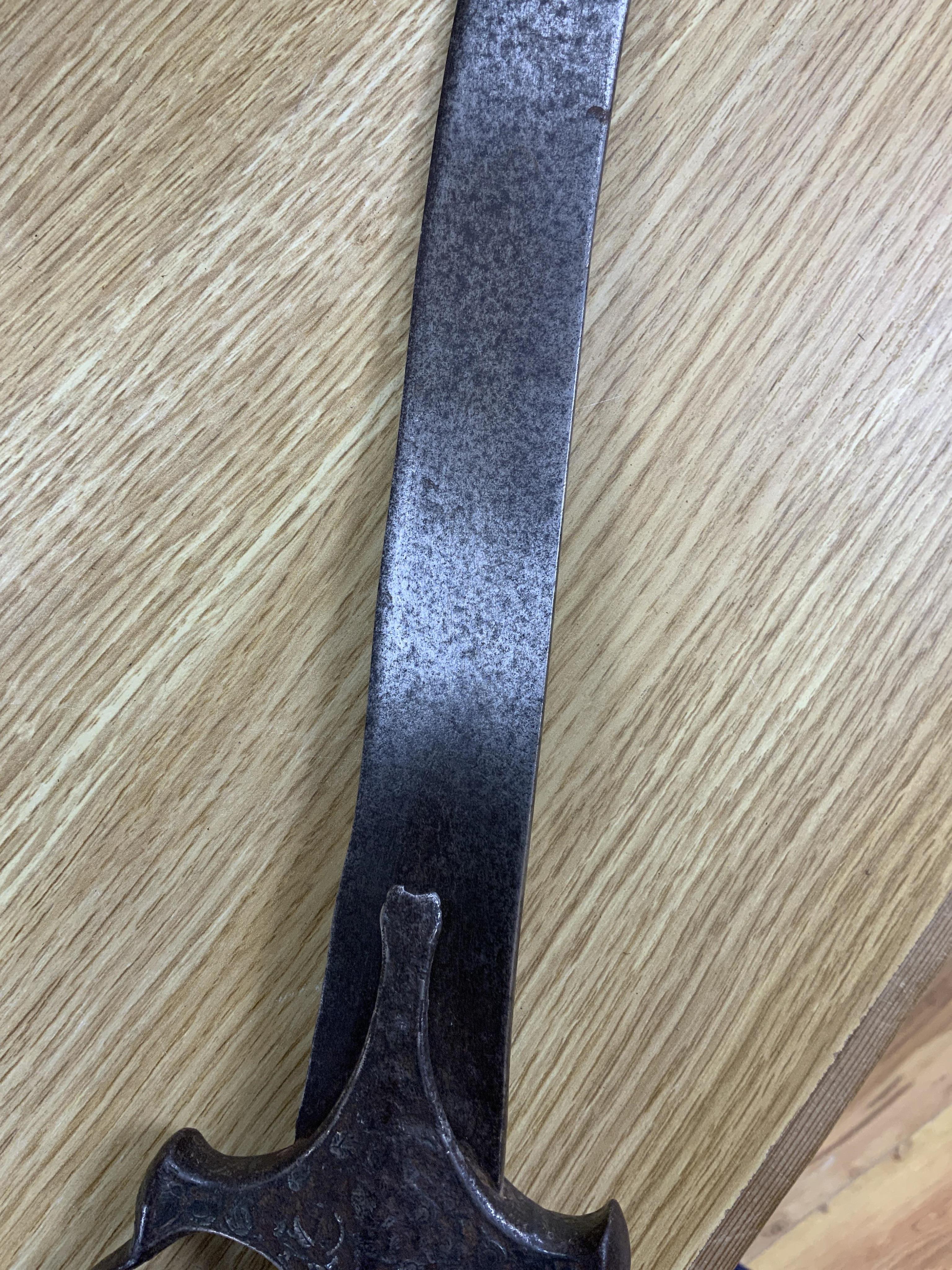 An Indian sword tulwar, the iron hilt with traces of chiselled and inlaid decoration, together with a kukri in its wooden scabbard, a Syrian jambya and a Moroccan jambiya (4)